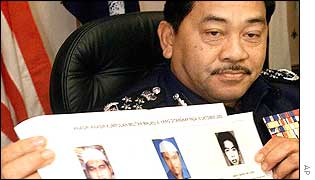 Malaysian police chief Norian Mai holds a copy of the photos of arrested militants on Wednesday