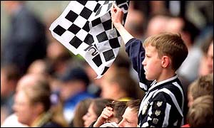 A Huddersfield fan cheers on his side