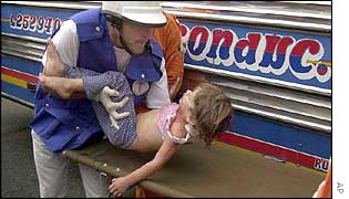 An injured girl is taken for treatment in Medellin