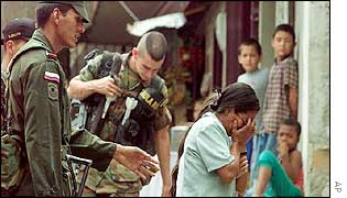 A mother weeps after her son is arrested