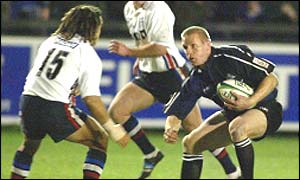 Sale's Vaughan Going stands up to a run from Glenn Metcalfe of Glasgow