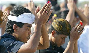 Balinese men pray for the bomb victims