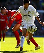 Leeds' Harry Kewell goes past Liverpool's Bruno Cheyrou