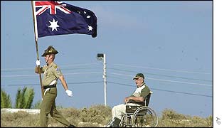 Bill Duff, in wheelchair, who was in the Australian air force during WWII near a soldier at the British cemetery in El Alamein