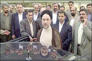 Iranian President Mohammad Khatami (centre) with MPs and bodyguards outside the parliament