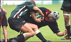 Kieron Dawson tackles Edinburgh's Dougie Hall and wins the ball for London Irish