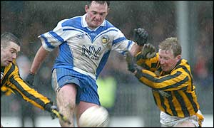 Dromintee's Aidan O'Rourke comes under pressure from Francie Bellew of Crossmaglen Rangers in the Armagh football final