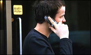 Man speaks on mobile phone in street