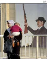 Iraqi woman with picture of Saddam Hussein