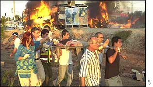 People carry a victim from the scene