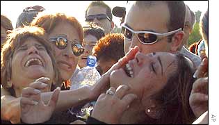 Ayelet, right, daughter of Ofra Burger, cries at her mother's funeral