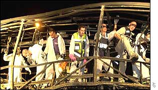Police examine the wrecked bus