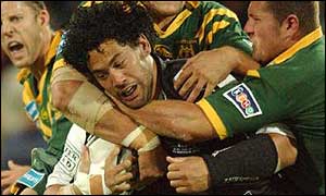 Ruben Wiki is tackled by the Australian defence