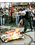 Palestinians burn a model of a Jewish settlement