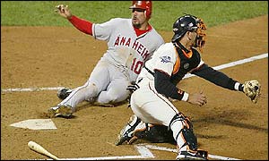 Benji Gil of the Anaheim Angels slides safely into home base in the second innings