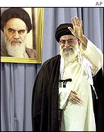 Ayatollah Khamenei by a portrait of Ayatollah Khomeini