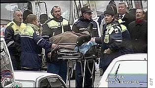 Officials push a body on a stretcher near the Moscow theatre