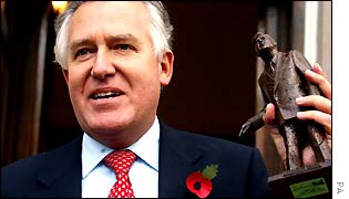 Peter Hain holds a statuette of Nye Bevan, the founder of the N.H.S. as he takes over from Paul Murphy as the Secretary of State for Wales, on the steps of the Welsh Office, London, Thursday 24 Octobe