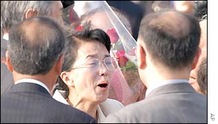 Fukie Hamamoto (centre) one of five Japanese kidnapped 24 years ago by North Korean spies, as she is greeted by her family members upon her arrival at Tokyo , 15 Oct 2002
