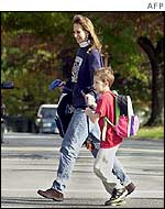 A woman takes her child to school in Maryland