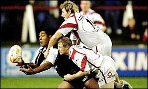 John Stanevitch (top) and Darren Albert put Ali Lauiti'iti under pressure