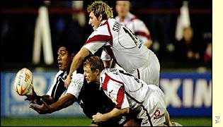 New Zealand's Ali Lauiti'iti is tackled by St Helens' John Stankevitch and Darren Albert
