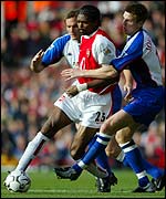 Arsenal's Kanu battles with Nils-Eric Johansson of Blackburn