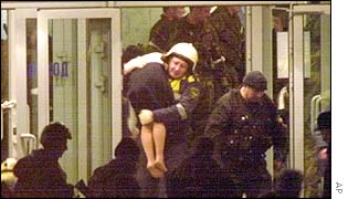 A woman being carried from the theatre