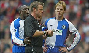 Blackburn's Dwight Yorke protests as team-mate Garry Flitcroft is sent off
