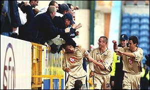 Nigel Quashie celebrates with Portsmouth fans
