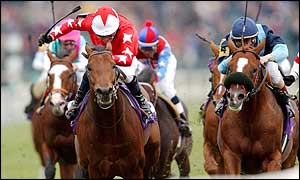 Mick Kinane tries to drive Rock of Gibraltar towards the line
