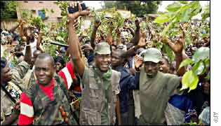 The rebel leader in Ivory Coast's north-west, Dosso (C), and his men are cheered by the crowd 