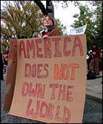 Protest placard: 'America does not own the world'