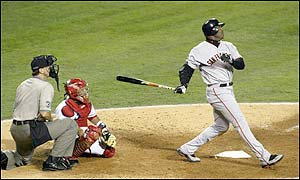 Barry Bonds of the San Francisco Giants hits a home run in the sixth inning giving the Giants a 4-0 lead - Kenny Lofton scores in the following inning to make it 5-0