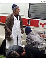 Medics attend an unidentified hostage outside the theatre