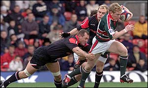 Leicester's Sam Vesty goes past Richard Hill 