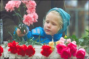 A girl deposits flowers
