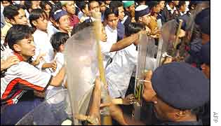 Angry supporters of Mr Ba'asyir try to break through a police barricade 