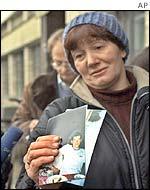 A mother with a picture of her son, one of those held hostage