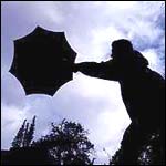 Man struggling with umbrella