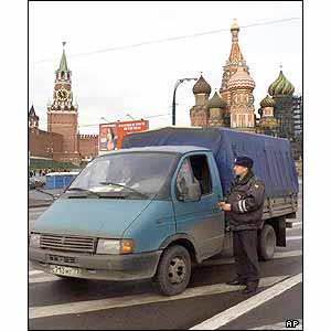 A police officer checks ID documents of a driver near the Kremlin