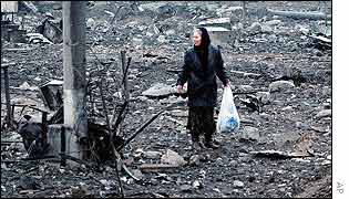 A woman walks among the rubble in the Chechen capital, Grozny