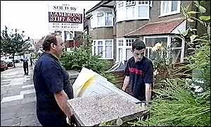 Removal men carrying a washing machine
