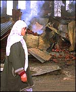 Woman near damaged building