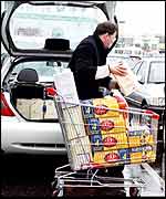 Man loading up car with cigarettes in France