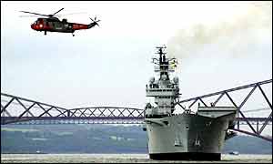 The HMS Ark Royal as it leaves Rosyth under the Forth bridge in Fife, Scotland 