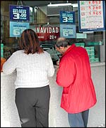 A couple fill in a lottery ticket