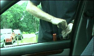 Thief breaking into car