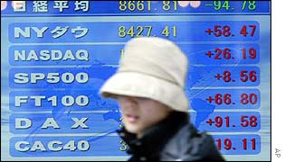 A woman in front of a stock board in Tokyo