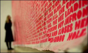 A woman looks at Arsewoman in wonderland by Fiona Banner 